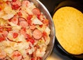 Horizontal image of southern style fried cabbage, onions, sausage and tomatoes
