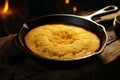 Cornbread baking in a castiron skillet capturing