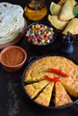 Cornbread and other mexican food - tacos, salsa with tomato, red onion, lime, cilantro, corn and hot pepper sauce, empanadas. Copy