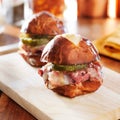 Corned beef and cheese sliders on pretzel bun