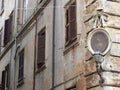 Corner of an ancient building with a frame with a painting of the Virgin Mary to Rome in Italy.