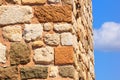 Corner of an antique building with byzantine ancient stonework against the sky