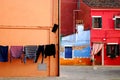 Corner beautifully designed with colorful houses and clothes to dry in Burano in Venice in Italy