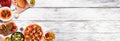 Corner border of a variety of delicious foods on a white wood banner background