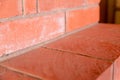 Corner brick red wall with gray lines closeup base design design background