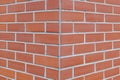 Corner brick wall with running bond pattern.