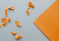 Corner brown paper with a copy of the space on a gray background and small torn and crumpled pieces of paper, a template Royalty Free Stock Photo