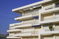 Corner of building with many windows balcony on blue sky Royalty Free Stock Photo