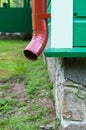 Corner of building with red metal drainpipe Royalty Free Stock Photo