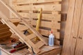 Corner of the carpenter full of wooden panels to be recycled. Wood on background. Chair in progress. Tools on the table