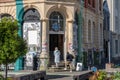 Corner city building entrance covered in messy bills and notices stuck to the exterior