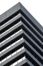 A corner detail of a typical brutalist style 1960s concrete office building with geometric concrete framework against a grey Royalty Free Stock Photo