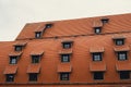 Corner with dormers Red Roofs of the city brown metal tiles roof of European house with windows. Typical European old Royalty Free Stock Photo