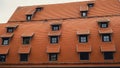 Corner with dormers Red Roofs of the city brown metal tiles roof of European house with windows. Typical European old Royalty Free Stock Photo