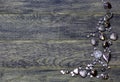 Corner frame border of Hearts beads on dark old wooden background.