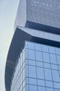 Corner of a glass futuristic building in the city center. With a space to copy. A view from below of modern skyscrapers Royalty Free Stock Photo