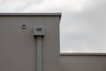 Corner grey of the house with flat roof with modern cube gray gutter pipe