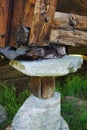 Corner of the house, backed by stones and logs Royalty Free Stock Photo