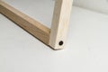 Corner made with raft wood sticks with black screw on a white table. Stop to make a frame. Royalty Free Stock Photo