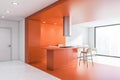 Panoramic orange kitchen with bar and sofa Royalty Free Stock Photo