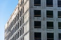 Corner of a monolithic building poured from concrete with windows Royalty Free Stock Photo