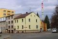 Corner municipal house seen from the other side of the intersection with chimney in the background