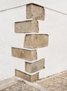The corner of an old building where the construction is reinforced with granite blocks Royalty Free Stock Photo