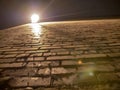 Corner of old rough and uneven brick wall in the light of a lantern, view from below Royalty Free Stock Photo