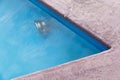 Corner of pool with spotlight under water Royalty Free Stock Photo