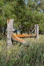 A corner fence post surrounded by long grass Royalty Free Stock Photo