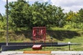 Corner with a red shield, shovel, buckets and a box of sand to extinguish the fire