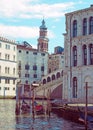 a corner the rialto area of central venice on a sunlit morning with gondolas moored next to the grand canal and old buildings Royalty Free Stock Photo