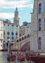 Corner the rialto area of central venice on a sunlit morning with gondolas moored next to the grand canal and old buildings Royalty Free Stock Photo