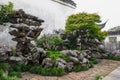 A corner with rockwork, tree and grass  in Master of the Nets Garden or Wangshi Garden in Suzhou Royalty Free Stock Photo