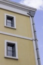 Corner shot of yellow painted masonry building in the morning