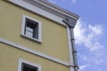 Corner shot of yellow painted masonry old building in the morning