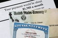 Corner of Social Security Administration annual statement with social secuiity check and ssn card.