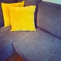 Corner sofa with bright yellow cushions