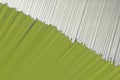 Corner of a stack of many sheets of thick paper or cardboard. One of the sides is green. Diagonal. Office abstraction. The topic Royalty Free Stock Photo