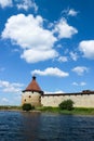 Corner tower of medieval Shlisselburg Oreshek fortress on the island in the Ladoga lake in Russia against blue sky Royalty Free Stock Photo