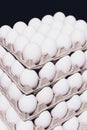 Corner of a tray of eggs on black background. 5 packs.