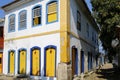 Corner of a two story colonial house with colorful facade in the late afternoon sun in historic town Paraty, Brazil Royalty Free Stock Photo