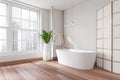 Corner view on bright bathroom interior with bathtub, panoramic window Royalty Free Stock Photo