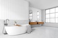 Corner view on bright bathroom interior with bathtub, panoramic window Royalty Free Stock Photo