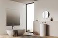 Corner view on bright bathroom interior with bathtub, panoramic window Royalty Free Stock Photo