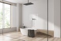 Corner view on bright bathroom interior with bathtub, panoramic window Royalty Free Stock Photo