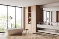 Corner view on bright bathroom interior with bathtub, panoramic window Royalty Free Stock Photo