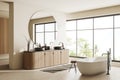 Corner view on bright bathroom interior with bathtub, panoramic window Royalty Free Stock Photo