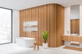 Corner view on bright bathroom interior with bathtub, panoramic window Royalty Free Stock Photo