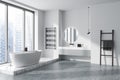 Corner view on bright bathroom interior with bathtub, panoramic window Royalty Free Stock Photo